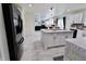 Modern kitchen with white cabinets, marble-like flooring, and an island with bar seating at 11149 Titania Ct, Noblesville, IN 46060