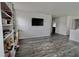Bright living room with wood flooring, a built-in bookshelf, and neutral color palette at 11149 Titania Ct, Noblesville, IN 46060