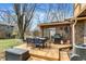 Outdoor deck with a table and chairs perfect for entertaining with a grill and a propane tank at 1123 Woodbridge Ln, Indianapolis, IN 46260
