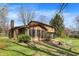 Backyard featuring a brick chimney, an outdoor sitting area, and a lush green lawn at 1123 Woodbridge Ln, Indianapolis, IN 46260
