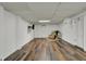 Basement featuring updated flooring and a cozy chair creating a welcoming space at 1123 Woodbridge Ln, Indianapolis, IN 46260