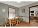 This dining room features a table, wood chairs, and an adjacent living area at 1123 Woodbridge Ln, Indianapolis, IN 46260