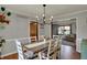 This dining room features a wooden table, chandelier, and gray walls at 1123 Woodbridge Ln, Indianapolis, IN 46260