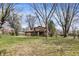 Charming home with a brick exterior and a well-maintained lawn and mature trees at 1123 Woodbridge Ln, Indianapolis, IN 46260