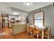 This kitchen features wood cabinets, stainless steel appliances, and an adjacent dining area at 1123 Woodbridge Ln, Indianapolis, IN 46260