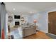 The living room features a brick fireplace, built-in bookshelves, and blue walls at 1123 Woodbridge Ln, Indianapolis, IN 46260