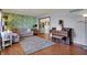 Spacious living room with wood floors, patterned wallpaper, and natural light at 1123 Woodbridge Ln, Indianapolis, IN 46260