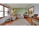 Bright living room with wood flooring, patterned wallpaper, and comfortable furniture at 1123 Woodbridge Ln, Indianapolis, IN 46260