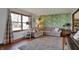 Comfortable living room with wood floors, floral wallpaper, and a neutral sectional sofa at 1123 Woodbridge Ln, Indianapolis, IN 46260