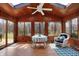 Charming sunroom featuring wood paneled walls, tile floors, skylight, and multiple windows at 1123 Woodbridge Ln, Indianapolis, IN 46260