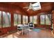Relaxing sunroom with wood paneled walls, ceiling fan, skylight, and natural light at 1123 Woodbridge Ln, Indianapolis, IN 46260
