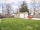 Spacious backyard featuring a two-car garage, outdoor furniture and a well-manicured lawn at 1139 N Butler Ave, Indianapolis, IN 46219