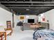 Large basement with combined living and bedroom areas and featuring an exposed ceiling at 1139 N Butler Ave, Indianapolis, IN 46219