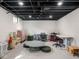 Finished basement features white walls, a black ceiling, and open floor plan at 1139 N Butler Ave, Indianapolis, IN 46219