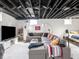Finished basement includes a seating area, TV, and carpet flooring at 1139 N Butler Ave, Indianapolis, IN 46219