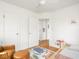 Neutral bedroom with hardwood floors, a leather chair, and playful decor at 1139 N Butler Ave, Indianapolis, IN 46219