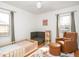 Brightly lit bedroom with hardwood floors, neutral colors, and stylish furnishings at 1139 N Butler Ave, Indianapolis, IN 46219