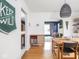 Open concept dining room featuring hardwood floors, modern light fixture, and view to the living room at 1139 N Butler Ave, Indianapolis, IN 46219