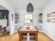 Well-lit dining room features hardwood floors, built-in shelving, and a cozy view into the living room at 1139 N Butler Ave, Indianapolis, IN 46219