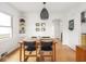 Bright dining room with a wooden table, modern light fixture, and access to other rooms at 1139 N Butler Ave, Indianapolis, IN 46219
