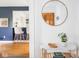 Stylish entryway featuring a round mirror, modern decor, and a glimpse into the open-concept living space at 1139 N Butler Ave, Indianapolis, IN 46219