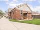 Brick home with a large backyard, covered patio and seating area, and manicured landscaping at 1139 N Butler Ave, Indianapolis, IN 46219