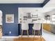 Modern kitchen featuring a breakfast bar with seating, bright countertops, and stainless steel appliances at 1139 N Butler Ave, Indianapolis, IN 46219