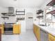 Bright kitchen featuring stainless steel appliances, hanging pot rack, and open shelving at 1139 N Butler Ave, Indianapolis, IN 46219