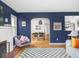 Spacious living room with a fireplace, hardwood floors, and an open view into the dining area at 1139 N Butler Ave, Indianapolis, IN 46219