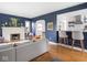 Open-concept living room with hardwood floors, a stylish bar area, and a cozy fireplace for entertaining at 1139 N Butler Ave, Indianapolis, IN 46219