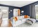 Cozy living room with a comfortable sectional sofa, hardwood floors, and an open doorway at 1139 N Butler Ave, Indianapolis, IN 46219