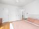 Bright main bedroom with hardwood floors, neutral colors, and closet doors at 1139 N Butler Ave, Indianapolis, IN 46219