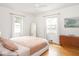 Bright main bedroom with hardwood floors, neutral colors, and a wooden dresser at 1139 N Butler Ave, Indianapolis, IN 46219