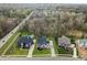 Aerial view showcasing three homes with expansive yards, mature trees, and neighborhood surroundings at 11640 Ansley Ct, Zionsville, IN 46077