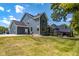 Spacious backyard featuring a manicured lawn, mature trees, and an outdoor seating area at 11640 Ansley Ct, Zionsville, IN 46077