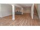 Spacious finished basement with wood-look floors, wet bar and stairs to the upper level at 11640 Ansley Ct, Zionsville, IN 46077