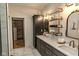 Elegant bathroom with double sinks, marble floors, decorative shelving and a walk-in closet at 11640 Ansley Ct, Zionsville, IN 46077