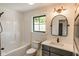 Bathroom featuring a tub and shower combo, classic fixtures, and modern vanity at 11640 Ansley Ct, Zionsville, IN 46077