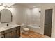 Bathroom featuring single vanity, black framed oval mirror, toilet and tub with shower at 11640 Ansley Ct, Zionsville, IN 46077