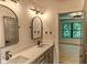 This bathroom features a dual vanity with black fixtures and a large oval mirror at 11640 Ansley Ct, Zionsville, IN 46077