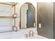 Elegant bathroom vanity with gold accents, open shelving, and stylish mirror at 11640 Ansley Ct, Zionsville, IN 46077