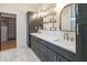 Modern bathroom features a double sink vanity, shelving, and large cabinet for ample storage at 11640 Ansley Ct, Zionsville, IN 46077