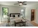Serene bedroom with natural light, stylish rug, and a comfortable bench at the foot of the bed at 11640 Ansley Ct, Zionsville, IN 46077