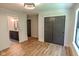 This bedroom shows sliding closet doors, wood-look flooring, and is open to the bathroom at 11640 Ansley Ct, Zionsville, IN 46077