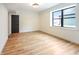 Bright bedroom with a large window, neutral walls, and wood floors, offering a serene and comfortable space at 11640 Ansley Ct, Zionsville, IN 46077