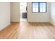 Bright bedroom leads into the en-suite bathroom; hardwood floors and a window fill the space with light at 11640 Ansley Ct, Zionsville, IN 46077