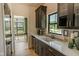 Butler's pantry with sleek countertops, custom cabinetry, and a convenient wine fridge for modern living at 11640 Ansley Ct, Zionsville, IN 46077