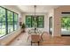 Bright dining room featuring hardwood floors, large windows, and a modern glass table at 11640 Ansley Ct, Zionsville, IN 46077
