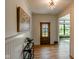 Inviting entryway boasts wood floors, striking artwork, and a clear view through the glass front door at 11640 Ansley Ct, Zionsville, IN 46077