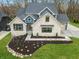 Striking two-story home featuring a stone facade, blue siding accents, and a well manicured front yard at 11640 Ansley Ct, Zionsville, IN 46077